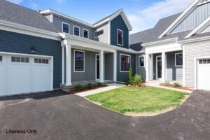 Modern townhouse at 30 Halcyon Drive with blue and gray siding, white trim, garages, and a green lawn.