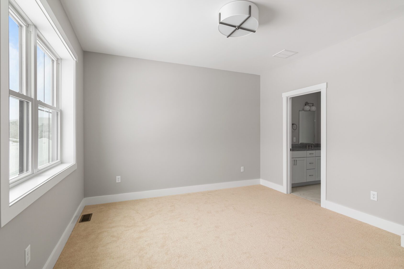 A room with a light fixture and carpet