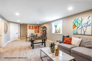 Bright basement game room at 68 Eden Lane with foosball table, Game On wall art, and colorful modern seating area.