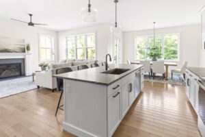 Bright, modern open-concept kitchen and living area at 385 Beaudry Lane with large windows and neutral decor.