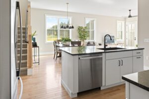 Modern kitchen at 68 Eden Lane with an island, dining table, and large windows letting in natural light.