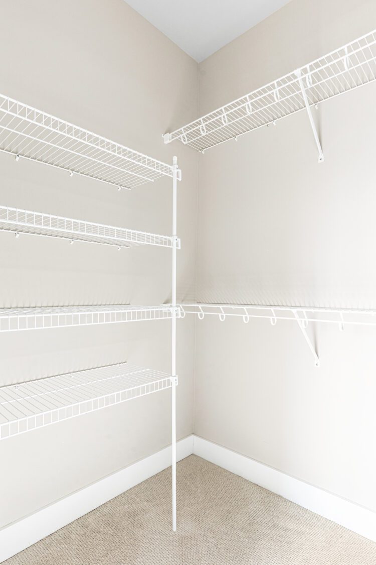 Empty walk-in closet at 188 Alpine Drive with white wire shelving, beige walls, and a carpeted floor.