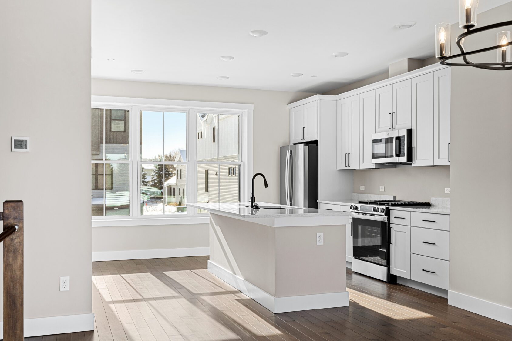 A kitchen with white cabinets and a black faucet at 188 Alpine Drive.