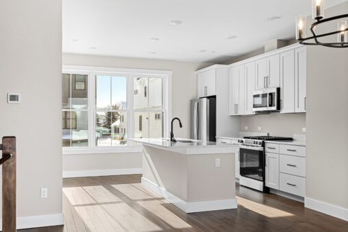 A kitchen with white cabinets and a black faucet at 188 Alpine Drive.