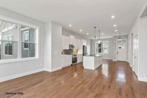 Bright modern kitchen at 136 Elm Street with white cabinets, stainless steel appliances, island, and hardwood floors.