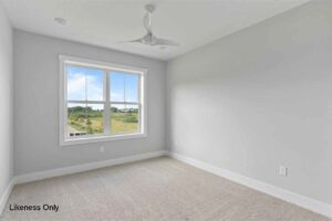 Empty room at 136 Elm Street with beige carpet, light gray walls, ceiling fan, and a window with a green outdoor view.