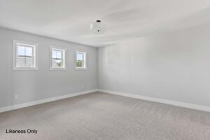 Empty room at 136 Elm Street with light gray walls, three windows, beige carpet, and a ceiling light fixture.