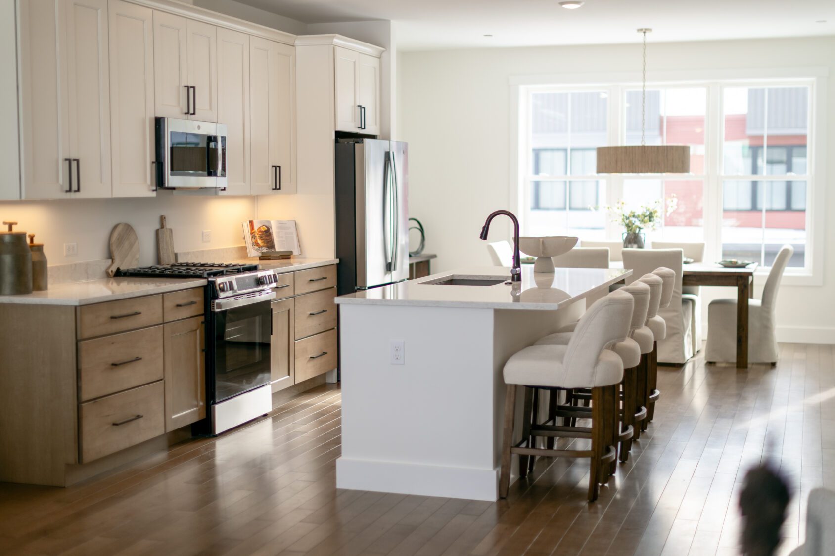 Modern kitchen at 196 Alpine Drive with light wood cabinets, stainless steel appliances, and a stylish dining area.