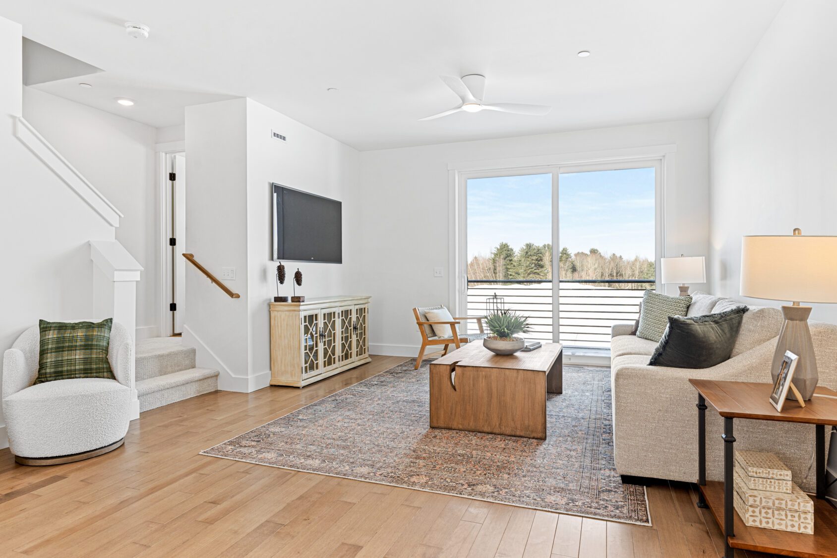 Modern living room at 196 Alpine Drive with neutral decor, cozy seating, and a wooden coffee table on a patterned rug.