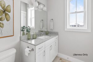 Modern bathroom at 196 Alpine Drive features white cabinets, granite countertop, large mirror, and natural light.