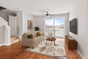 Modern living room at 196 Alpine Drive with beige sofa, TV, round coffee table, and snowy view through a large window.