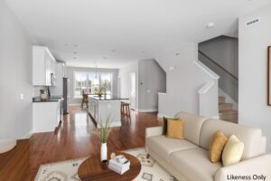 Modern open-concept living room and kitchen at 196 Alpine Drive with wood floors, neutral decor, and natural light.