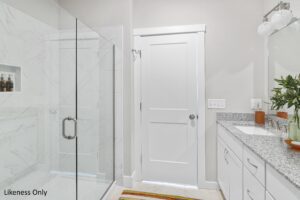 Modern bathroom at 196 Alpine Drive with glass shower, white cabinets, granite countertop, and a potted plant by the sink.