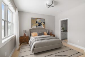 Bright bedroom at 196 Alpine Drive with a modern bed, nightstands, abstract art, and view into the bathroom.