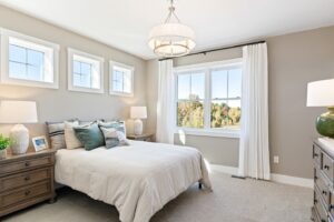 Bright bedroom at 162 Alpine Drive with a large bed, nightstands, dresser, and big windows with white curtains.